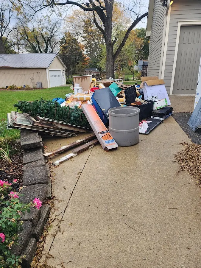 Dumpster being loaded with debris for Roofing Dumpster Rental in Chicago Heights